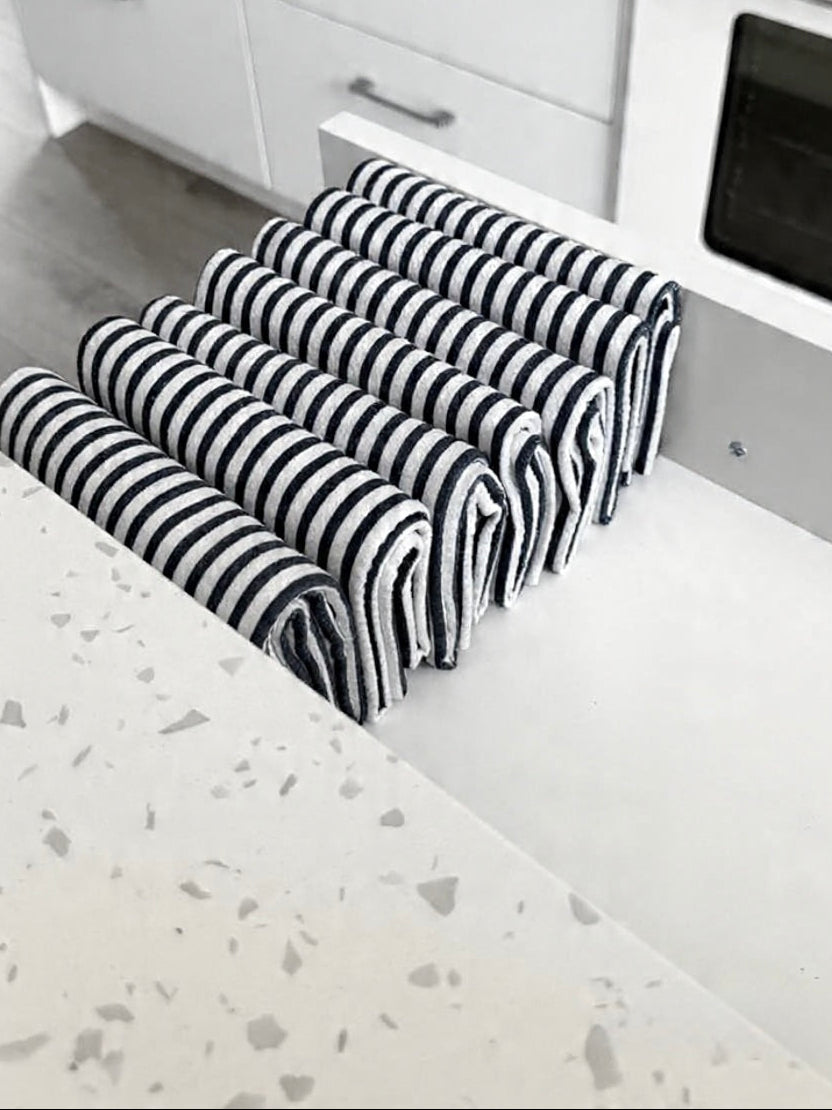 Stack of Blue and White Striped Towels Organized in a Drawer